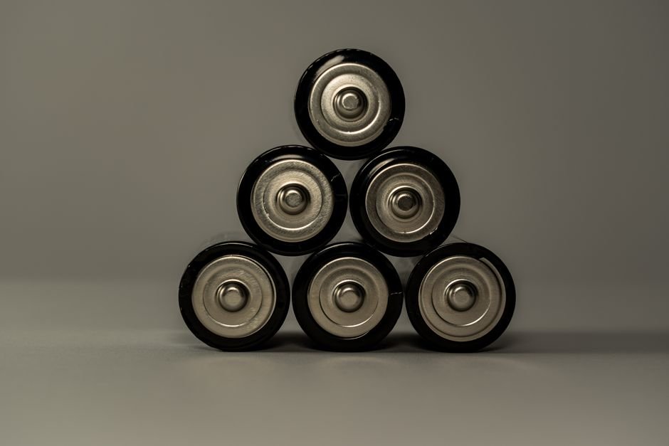 An EV battery pack with cooling channels and thermal management hardware visible between cell modules