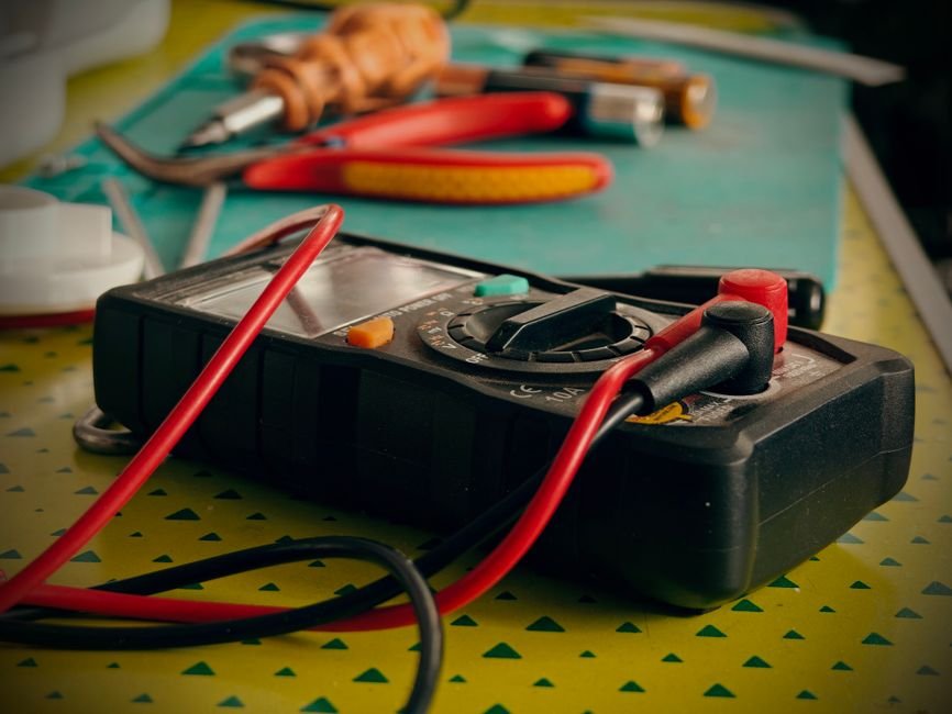A battery testing meter connected to a cell to measure resistance