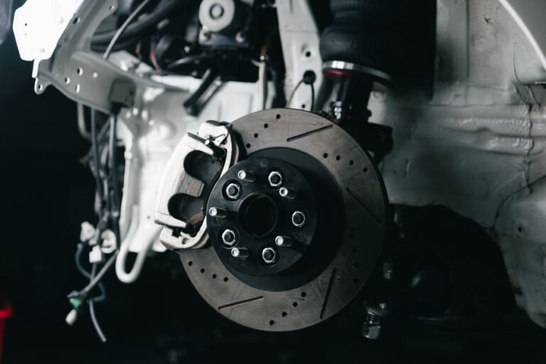 Close-up of a car's brake disc glowing red-orange from heat buildup
