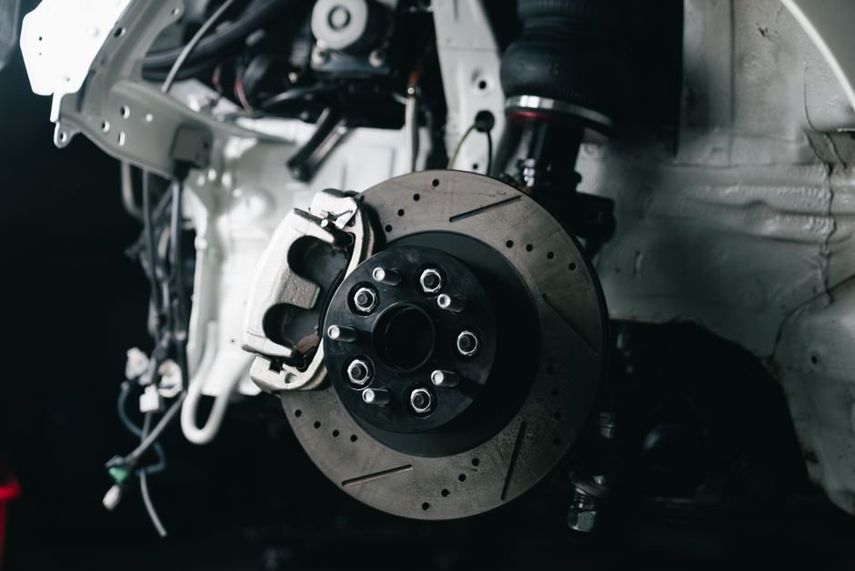 Close-up of a car's brake disc glowing red-orange from heat buildup