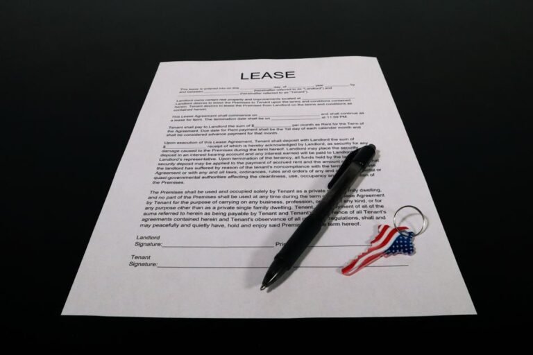 A set of car keys resting on printed vehicle paperwork on a table