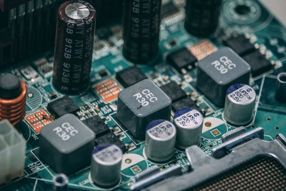 A battery management system circuit board mounted next to lithium-ion cells