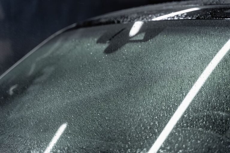 Close-up of a small chip in a car's windshield glass
