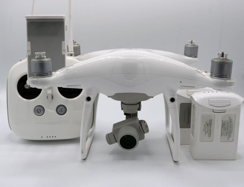 A drone battery pack being inserted into the battery compartment of a drone