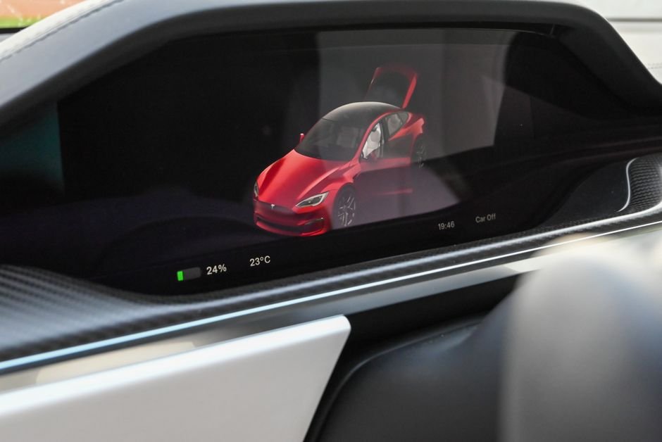 A close-up of an electric car's dashboard showing the battery charge gauge