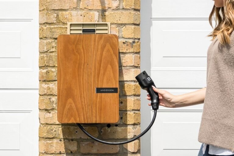 An electrician installing a Level 2 EV charging unit on a garage wall