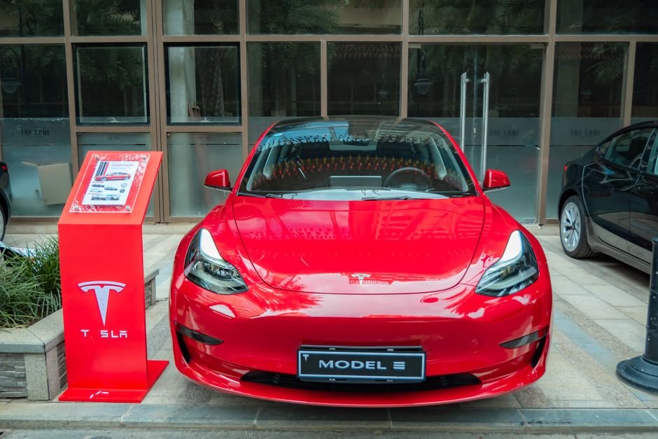 An electric car on display inside a dealership showroom