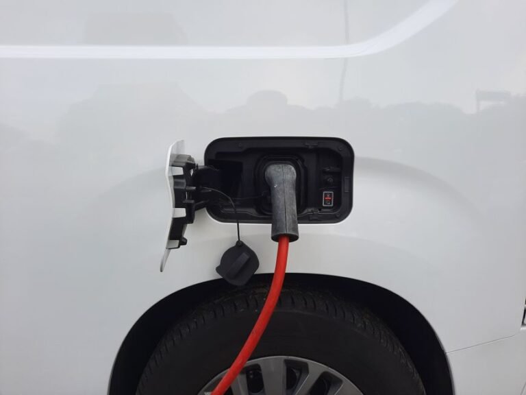 A fuel economy and environment label on the side window of a new electric car at a dealership