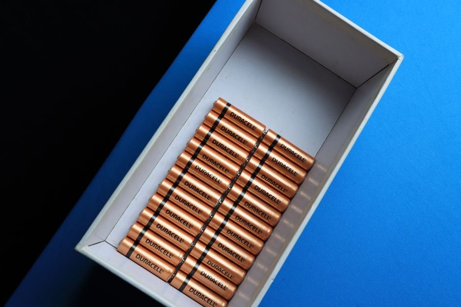Two boxed replacement batteries placed side by side on a table for comparison