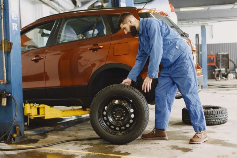 A mechanic rotating a tire in a repair shop