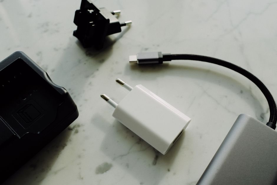 Several charging cables and power adapters spread out on a table