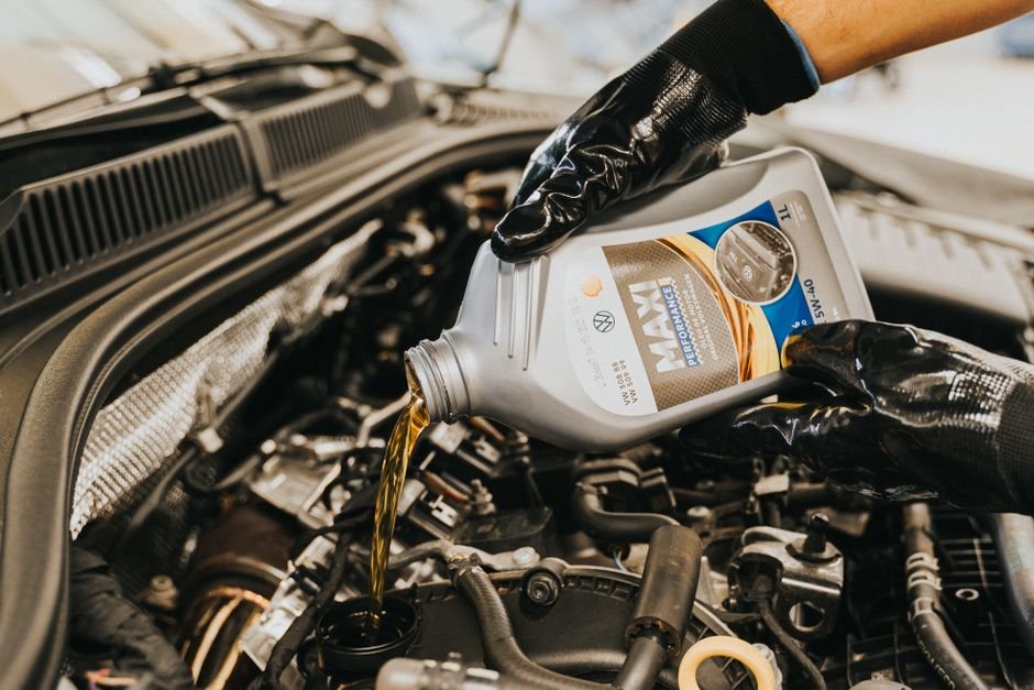 Motor oil being poured into a car engine