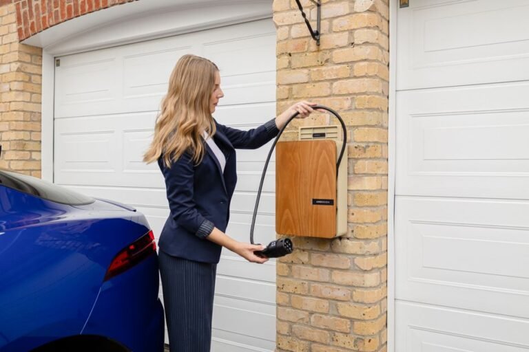 A person plugging a charging cable into an electric vehicle in a home garage